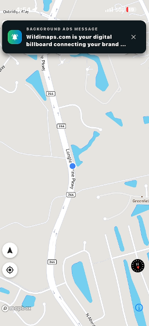 A WilDi city-wide background ad delivered on a driver's phone
